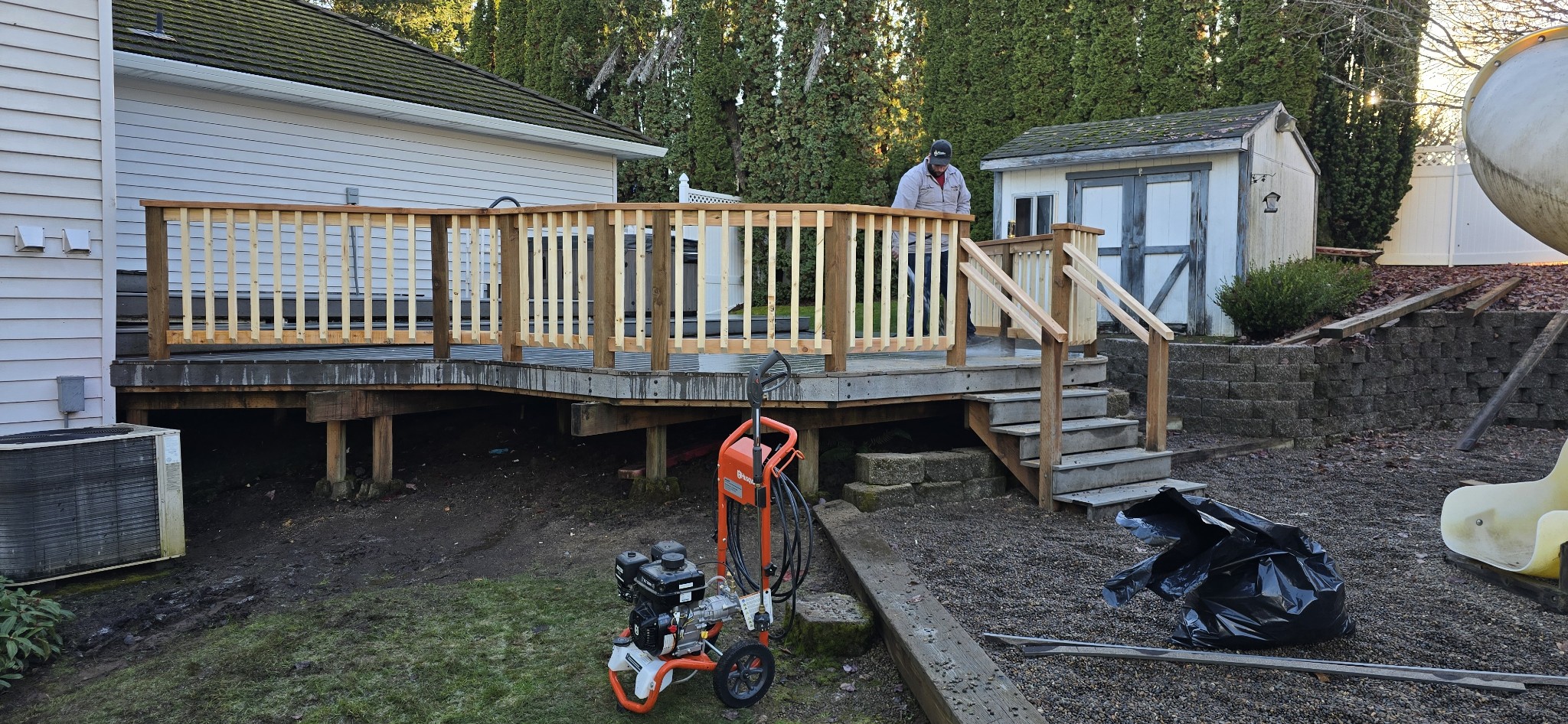 Crew finishing a cedar deck railing and stairs