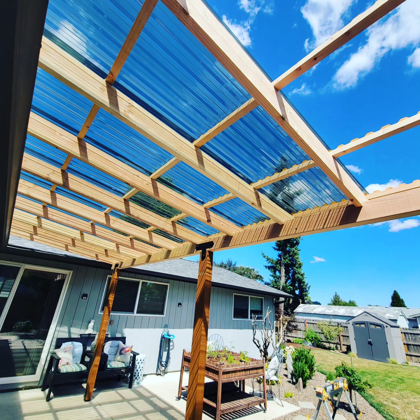 Polycarbonate roofed patio cover over a back deck